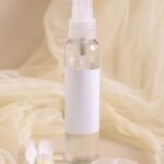 spray-refillable-bottle-near-orchid-flowers-and-tu-2025-03-13-11-59-39-utc